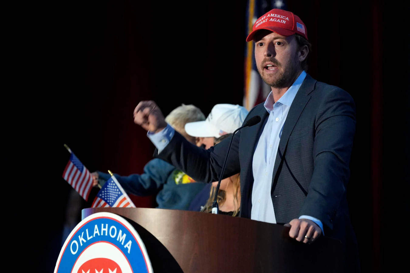 Oklahoma education superintendent wearing MAGA hat speaking at podium