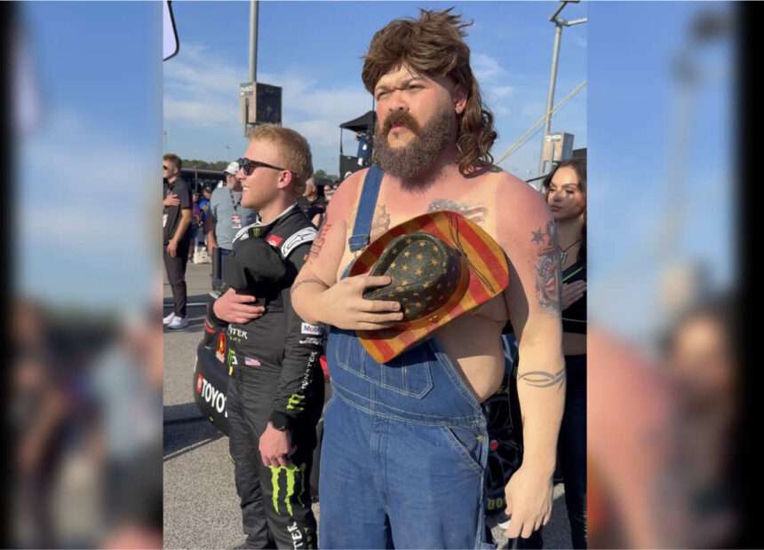 Comedian Druski in overalls and mullet disguise at NASCAR event