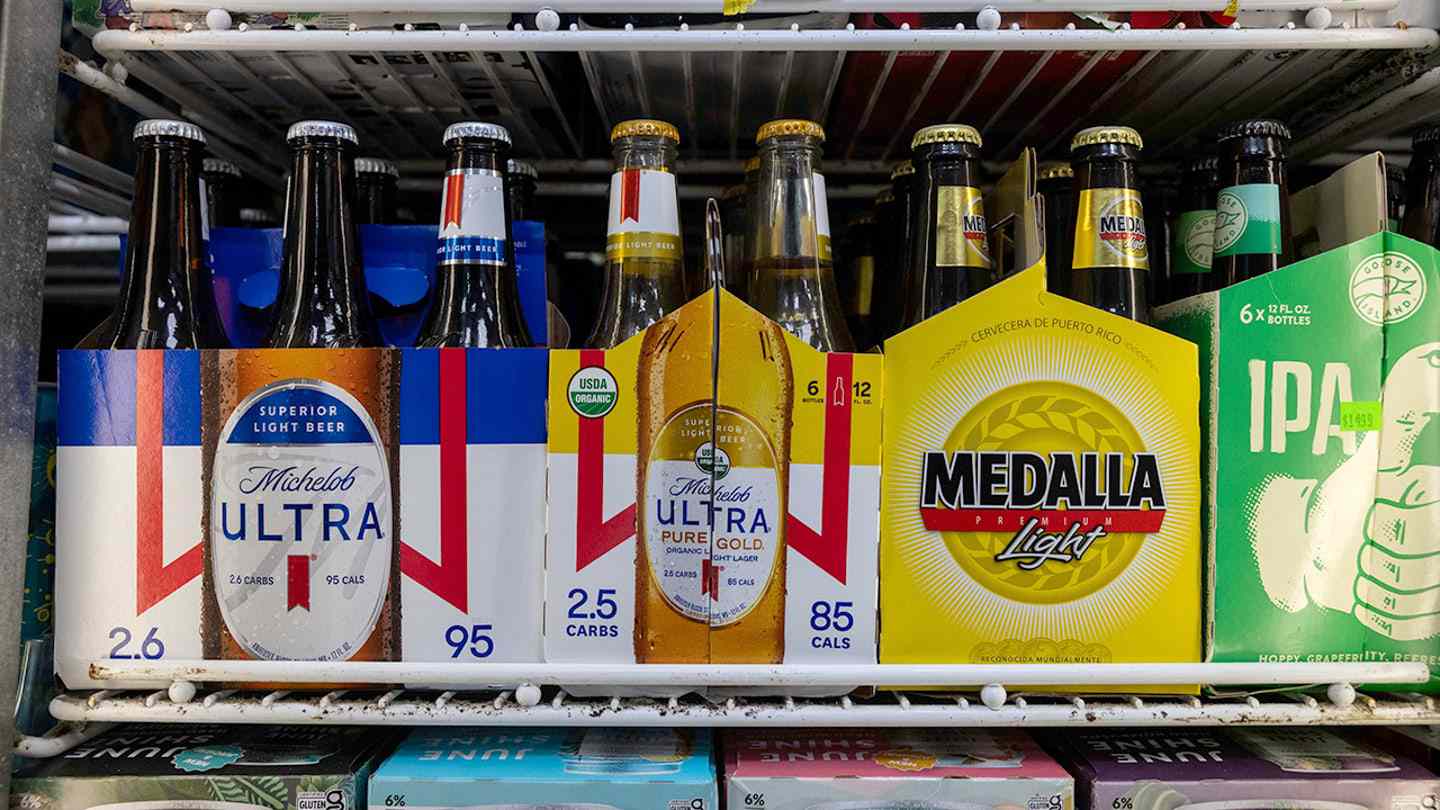 Michelob Ultra and Modelo beer packages inside a store refrigerator