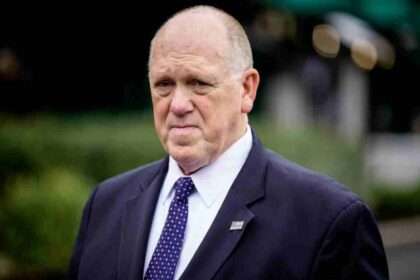 Tom Homan wearing a suit outside during a press appearance