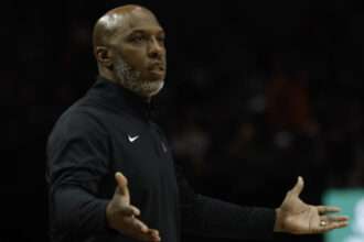 Chauncey Billups gestures courtside during a basketball game.
