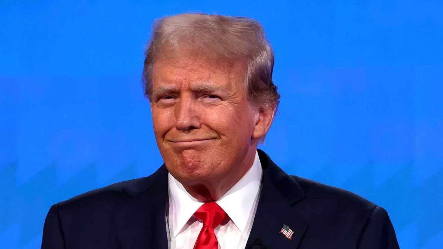 Donald Trump smirking during a press conference