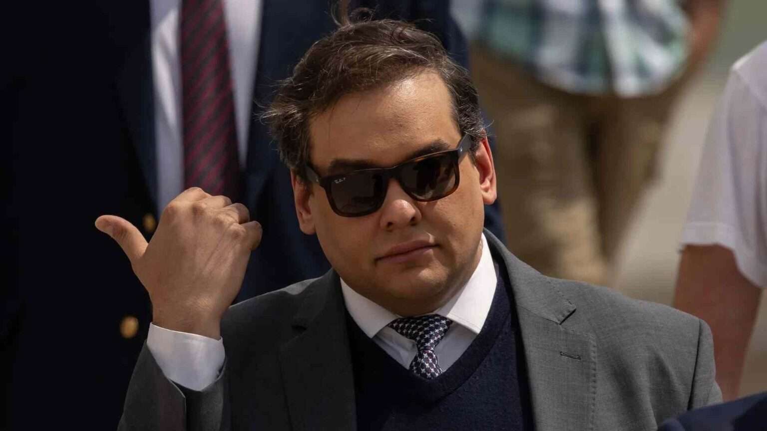 Former congressman George Santos wearing sunglasses after early release