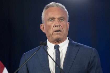 Robert F. Kennedy Jr. speaking at a podium.