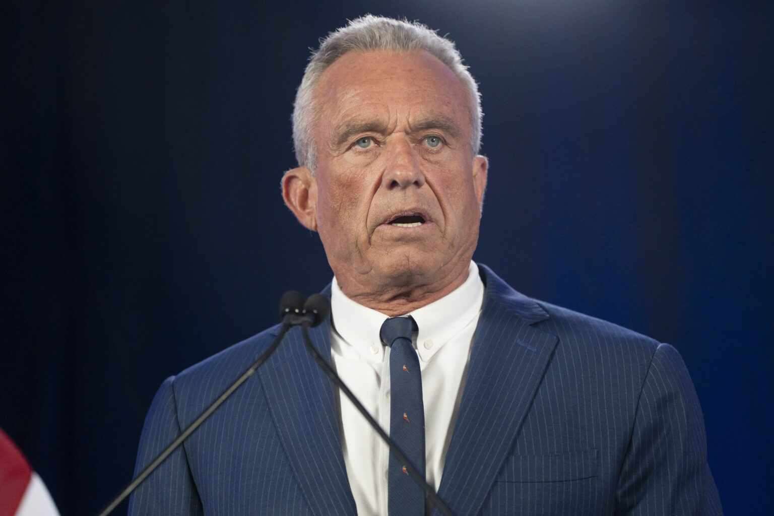 Robert F. Kennedy Jr. speaking at a podium.
