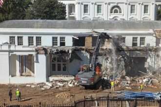 Construction machinery demolishing part of the White House East Wing