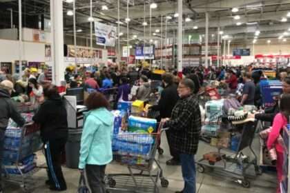 Busy Costco store with long checkout lines during holiday shopping